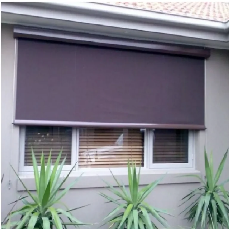 Dark canvas blind installed externally over a window on a rendered home.